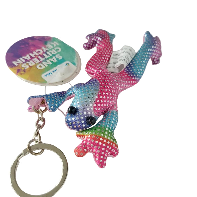 Roze zanddier kikker sleutelhanger met voelbaar zand, compact sensorisch materiaal voor friemelen, fijne motoriek en concentratie, bevestigd aan sleutelring.