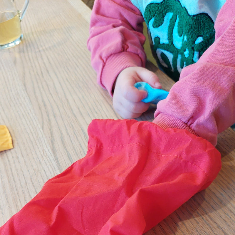 voelmemory in zak, voel kussentjes, sensoriek spel, kind met een hand in voelzak, met de andere een memory stuk in de hand