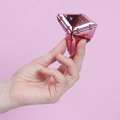 Hand die Speks Geode Pyramid magnetische driehoeken vasthoudt en fidget gebruikt voor focus en ontspanning