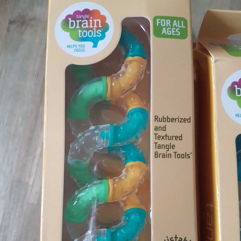 Therapytangle medium oranje in verpakking, motoriek fidget